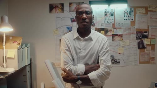 Detective Posing against Investigation Board in Office at Night