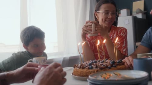 Happy Family Celebrates Birthday with Cake and Candles