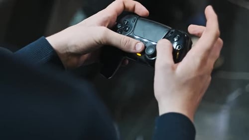 Teenage Boy Controls a Joystick in His Hands in a Game Zone Entertainment Center