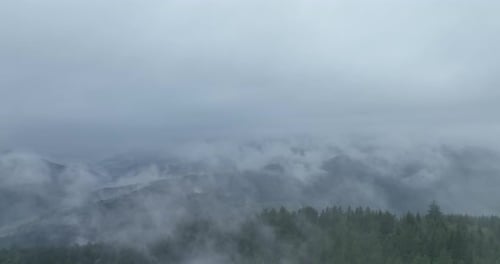Mountains Emerge from Mist in Aerial Wilderness View