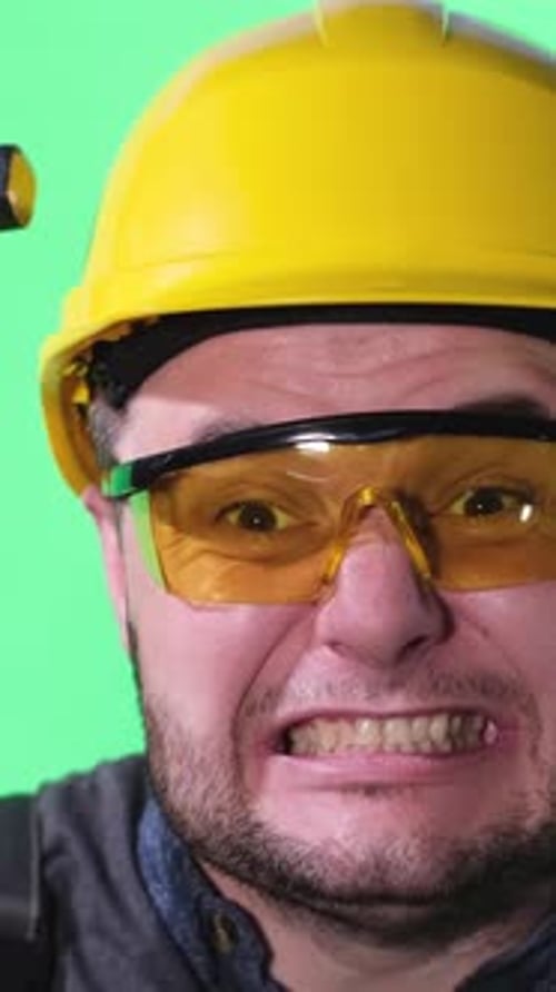 Construction Worker Strikes with a Hammer Using a Handheld Metal Tool Vertical Video