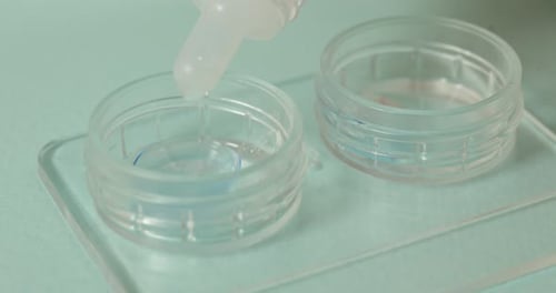 Clear Liquid Dripping into Contact Lens Case