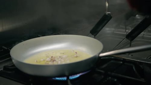 Onions and Herbs being Cooked in Pan