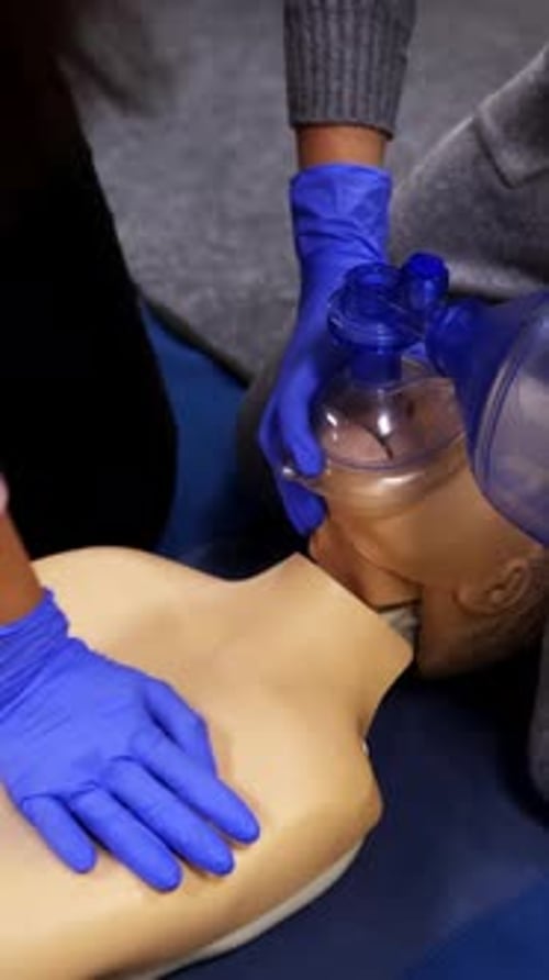 Hands Demonstrate CPR on Medical Training Dummy
