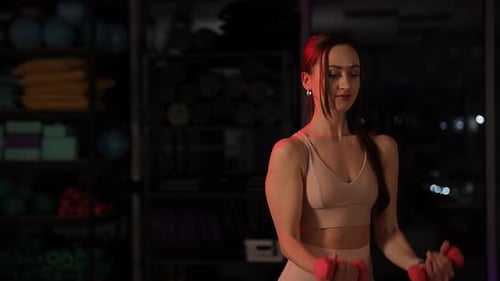 A Passionate Fitness Enthusiast is Doing an Intense Dumbbell Workout at a Modern Gym