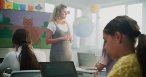 Female Teacher Guiding Young Kids During Art Lesson Primary School Girl Creating Drawing on Laptop