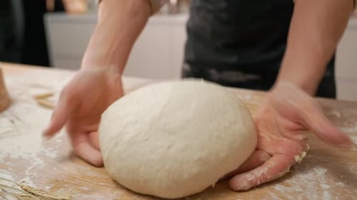 Hands Working Dough in Kitchen