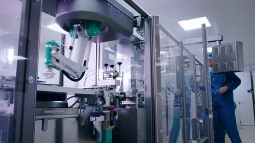 Engineer Starting Packaging Line at Pharmaceutical Plant. Pharmaceutical Manufacturing Line. Factory