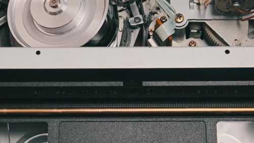VHS Video Cassette Put Inside VCR Recorder and Playing