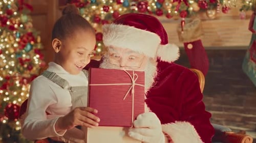 Girl and Santa Claus Opening a Christmas Gift