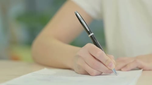 Hand Close Up of Woman Writing on Paper