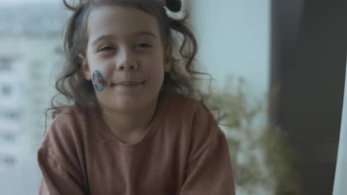 Cute Girl Smiling with Stickers on Her Face