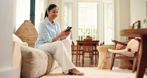 Smile, woman and typing with phone on sofa for online comment, social media post or web browsing