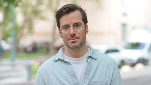Man with Glasses Smiling Outside
