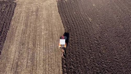Spring Agricultural Field Work, Tractor With Seeder Sow Seeds in Ground Aerial Slow Motion