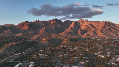 Cinematic drone at twilight of Tuscon Arizona with mountains in the background