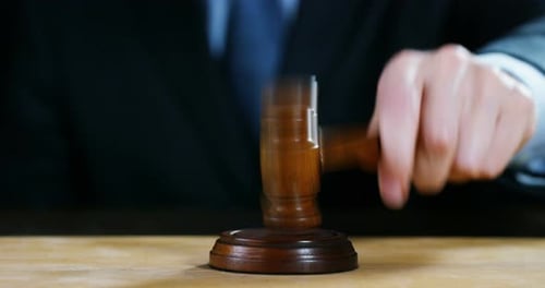 Judge Strikes Gavel on Stand in Courtroom