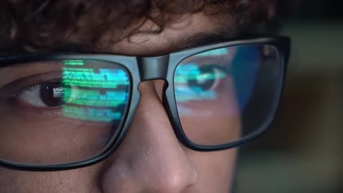 Intense Programmer Working, Code Reflected in Glasses