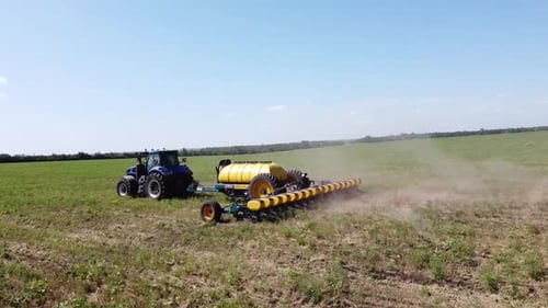 Blue Tractor O.A. Planting Canola On No Till Field
