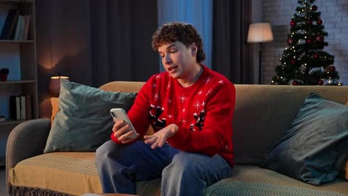 Young Adult Video Calling at Christmas Indoors
