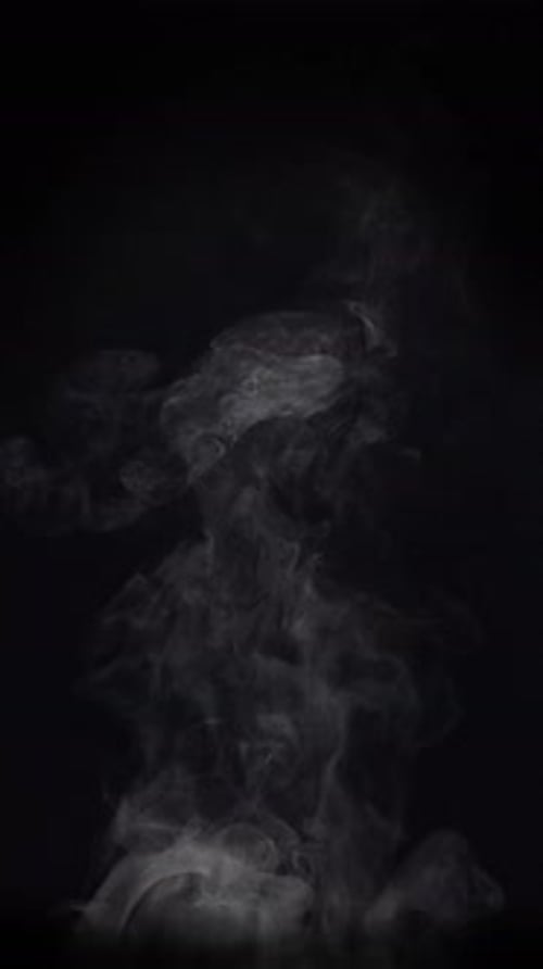 Billowing Smoke Ascends on Black Background