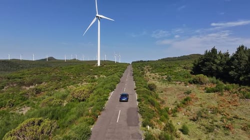 Aerial View of a Car Driving on a Rural Road