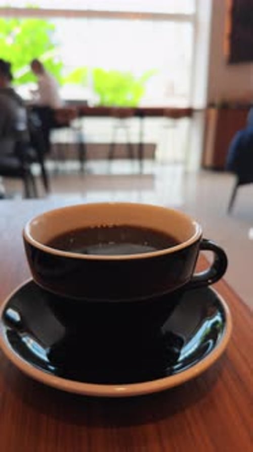 CloseUp of a Warm Cup of Coffee in a Stylish Caf Setting