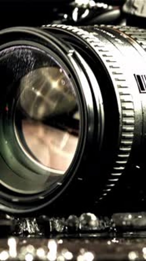 The Camera Falls with Splashes on the Wet Table Filmed on a Highspeed Camera at 1000 Fps