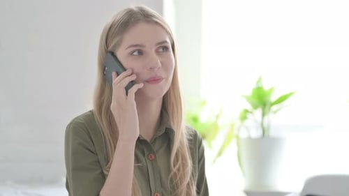 Smiling Woman Chatting on her Mobile Phone
