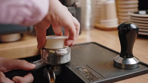 Professional Barista Prepares Coffee Using Portafilter