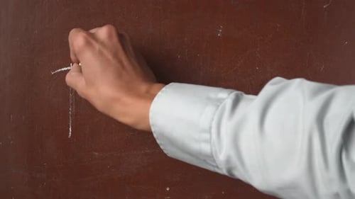 Hand Writing Tuesday on Chalkboard Surface