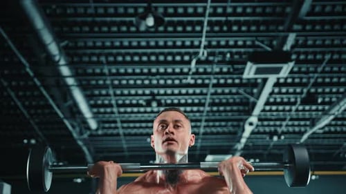 Muscular Man Weightlifting at Gym Focusing on Strength and Endurance for Fitness Journey