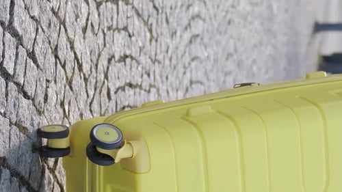 Slow Motion of a Female Tourist Walking Down the Street and Carrying a Suitcase Vertical Video