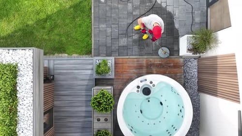 Man Cleaning Resting Area at His Backyard Using Pressure Washer