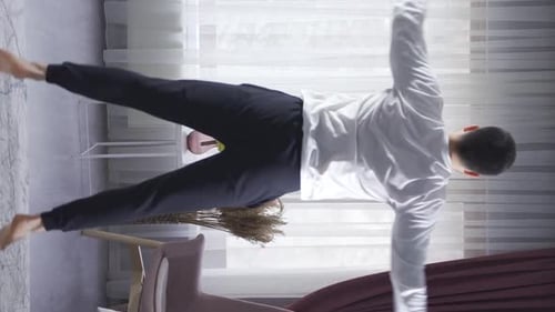 Young Man Exercising in Brightly Lit Home