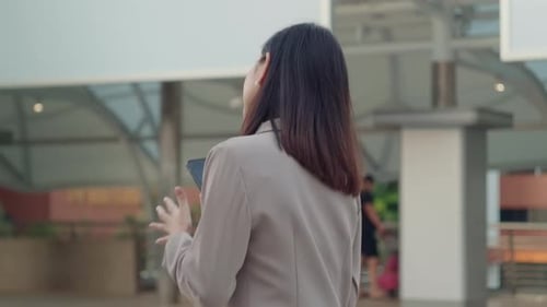 A young beautiful businesswoman is using Smart phone in Modern city