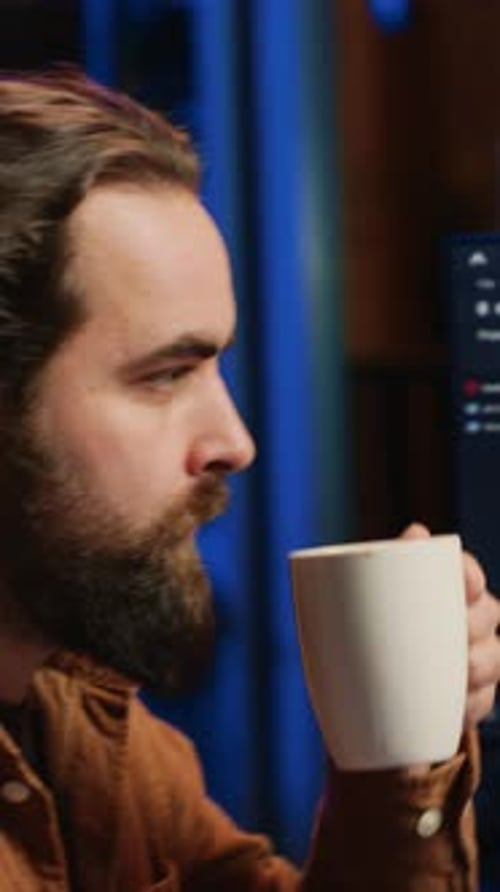 Computer Scientist Drinking Cup of Coffee While Developing Code on PC
