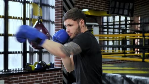 Collected Sportsman in the Boxing Hall Practicing Boxing Punches During Training