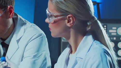 Scientists Work in a Lab with Computers and Microscope