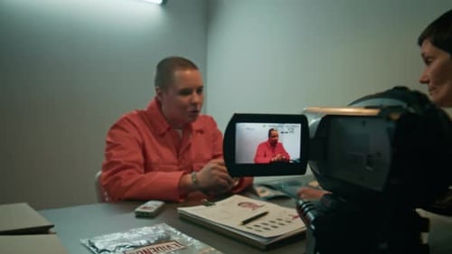 Police Investigator Interviewing Young Adult Prisoner