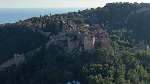 Aerial View of an Ancient Fortress with Walls Extending Across Hills