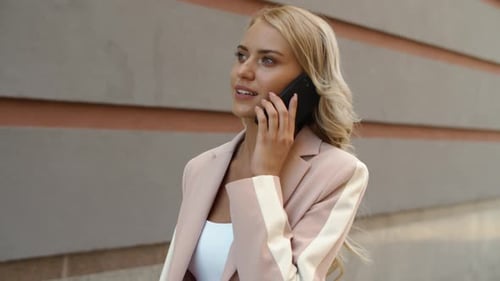 Close Up Smiling Woman Talking Phone In Pink Jacket At Street. Happy Businesswoman Speaking Mobil...