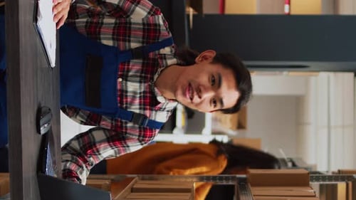 Young Adult Employee Works in Distribution Warehouse