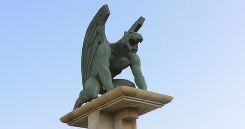 Ferocious large bronze green Gargoyle statue overlooking the landscape -Close up