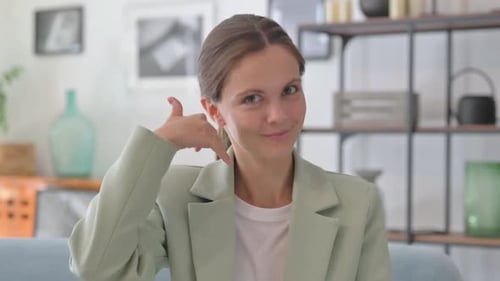 Call Me Gesture by Young Businesswoman in Creative Office