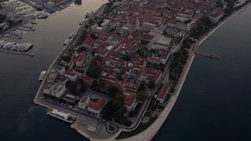 Aerial view of old town, harbour, and boat in sunrise, Zadar, Croatia.