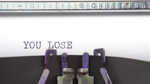 You lose phrase closeup being typing and centered on a sheet of paper on old vintage typewriter