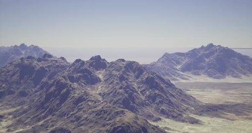 Mountain Landscape Under Clear Skies with Distant Horizon Visible