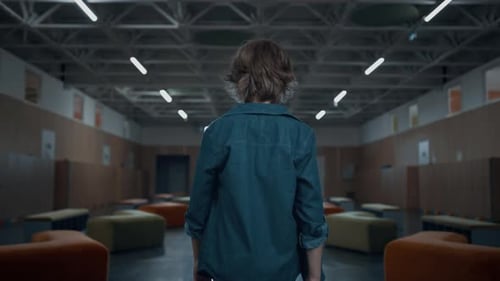 Unknown Teen School Boy Walking Empty Hallway Heading Staircase Alone Rear View