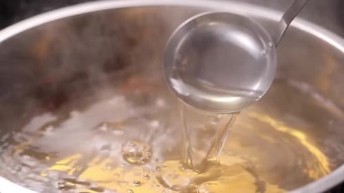 Perfect Stock Base Ladling Hot Broth from the Boiling Pot